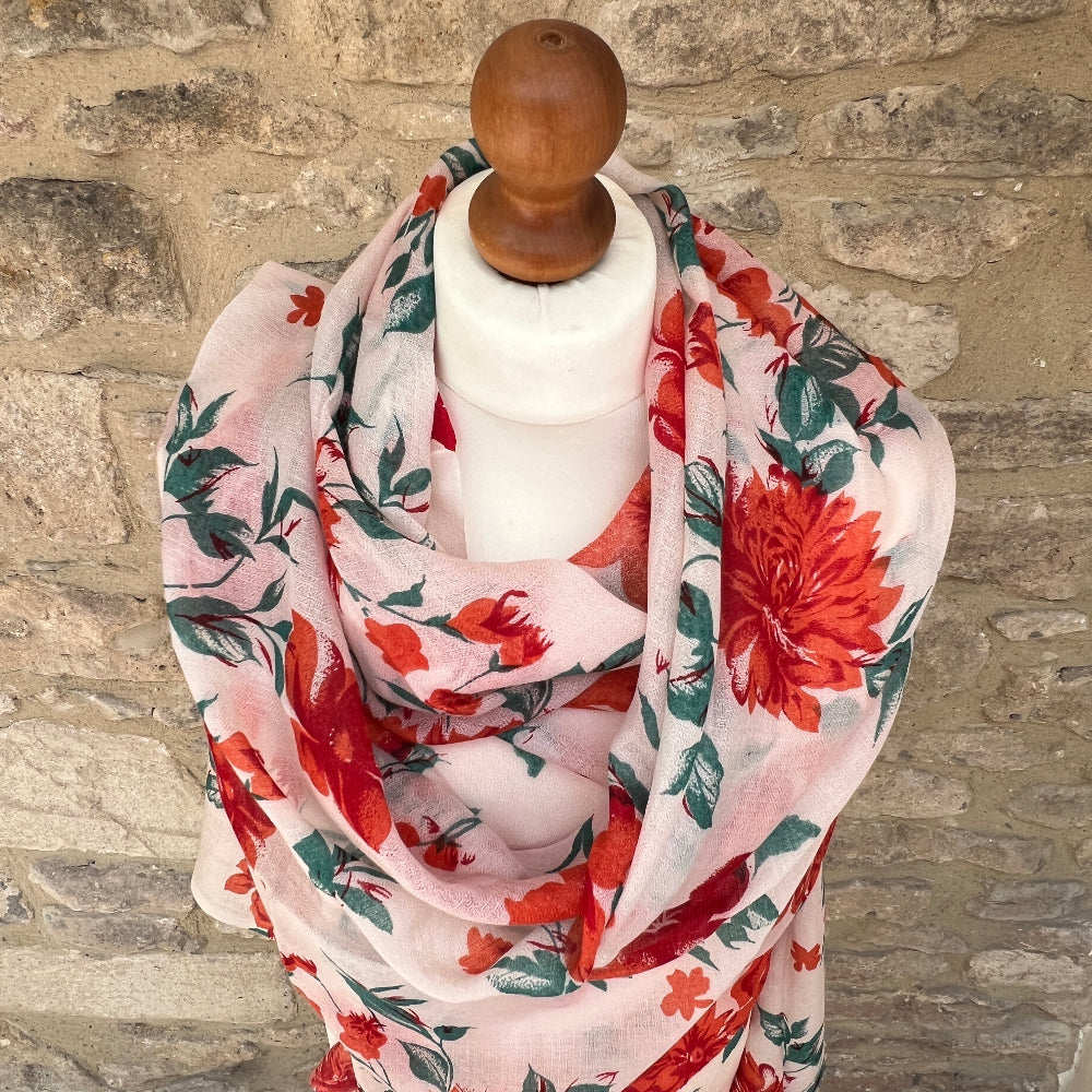Floral cashmere pashmina / scarf on a mannequin against a stone wall background