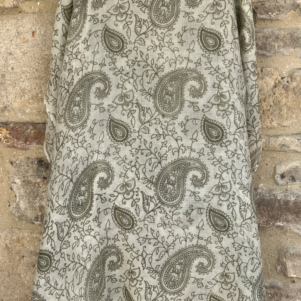 Close up full length cashmere pashmina with paisley pattern on a stone background