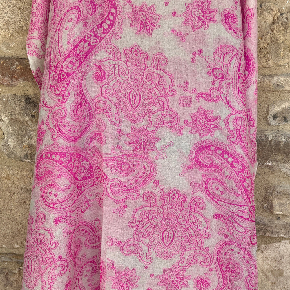 Pink paisley patterned cashmere  pashmina on a stone surface