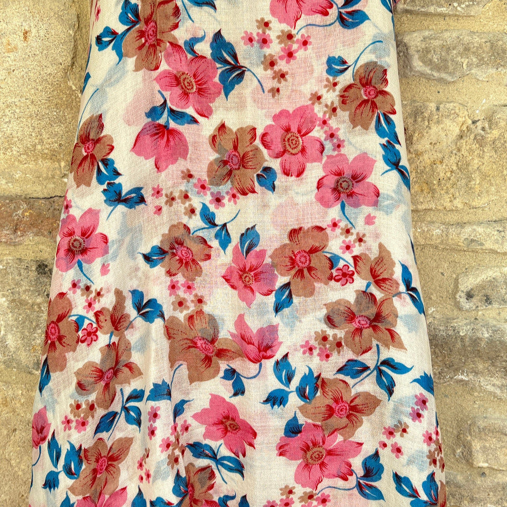 Full length floral cashmere pashmina with pink, blue, and brown flowers on a beige background