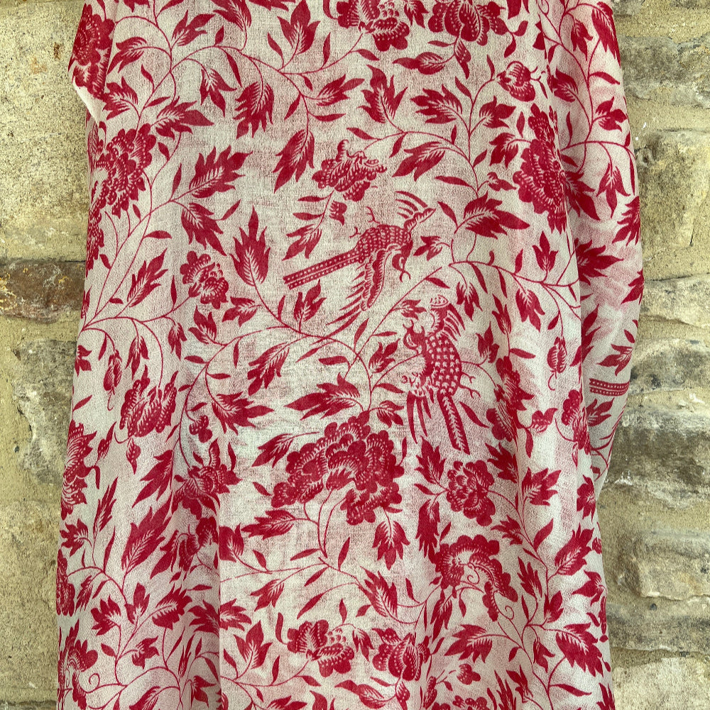 Red floral patterned cashmere pashmina scarf  on a textured stone background