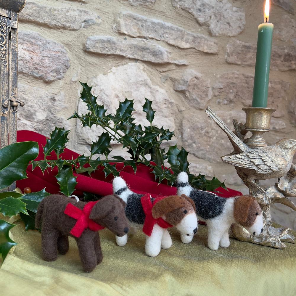 Meet &#39;Patch&#39;, a charming felted wool dog that brings artisanal character to any space.

This medium-sized companion features a distinctive patchwork design with rich brown tones, complemented by a striking crimson scarf. Meticulously hand-stitched from premium wool, each piece showcases the craftsmanship of its maker.

Perfect as a standalone decorative accent or thoughtful gift.

Shown with a Bird candle holder on red and gold fabric with a stone wall background. 