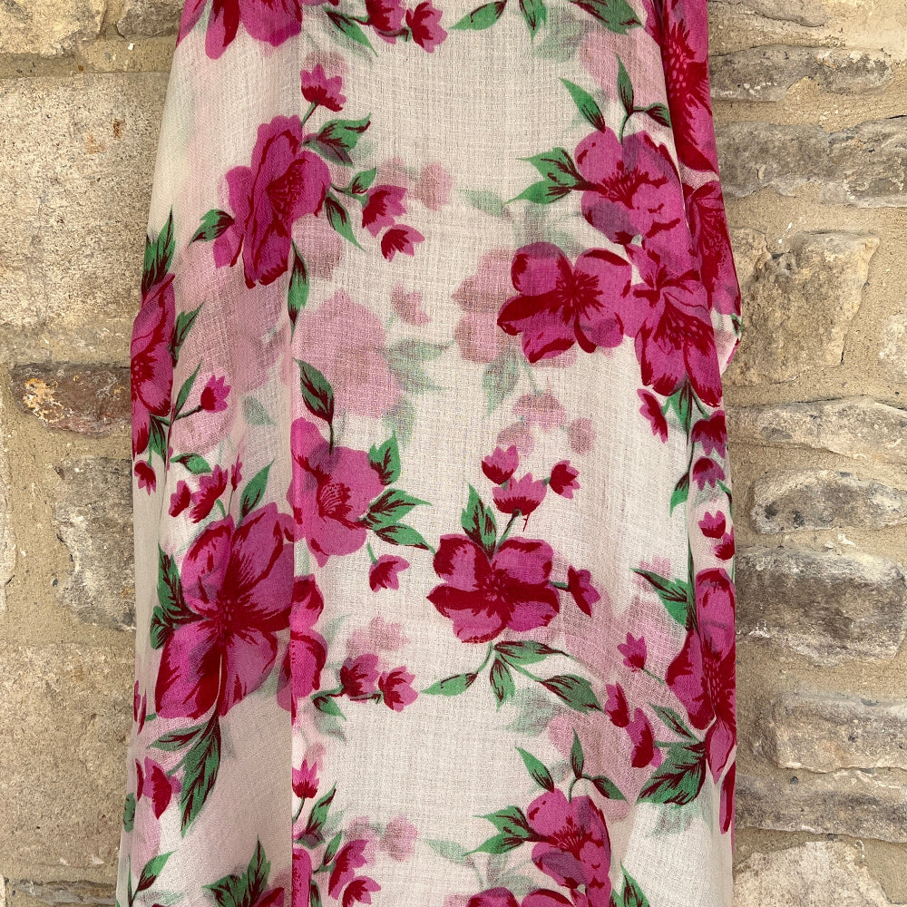 Floral patterned cashmere fabric draped over a stone surface