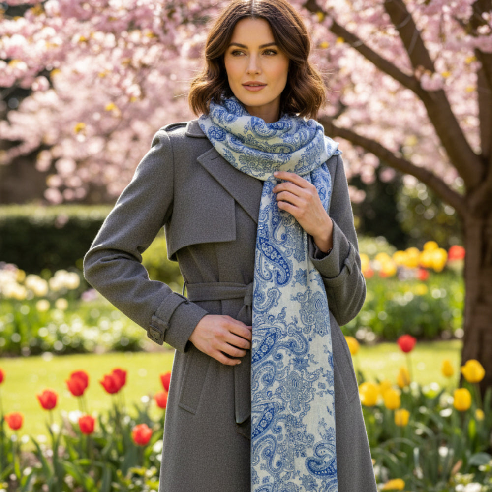 Blue and white paisley cashmere pashmina scarf on a stone surface