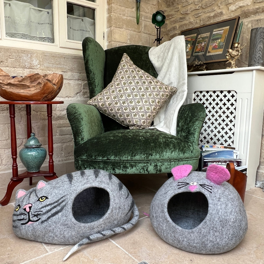 Green velvet armchair with a stone wall and wooden side table and decorative items showing your cat&#39;s new favourite hideaway!

Handcrafted from 100% New Zealand felted wool and dyed with nature&#39;s own palette, these &#39;Cat&#39; &amp; &#39;Mouse&#39; caves are the ultimate cosy retreats. Soft, warm, and naturally breathable, it keeps your feline friend comfortable while maintaining that fresh-air feel—no synthetic nasties here.
