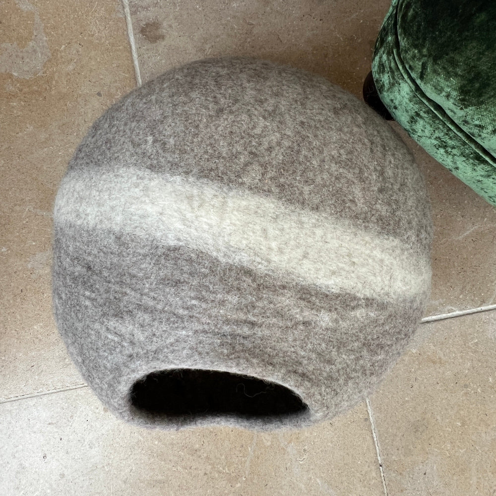 Treat your furry friend to a sanctuary crafted with care.

This handmade felted wool pet cave combines luxury with purpose—soft, warm, and breathable for ultimate comfort. Crafted from 100% New Zealand wool and coloured with natural dyes, it&#39;s completely chemical-free and kind to the environment.

The chocolate and cream striped design adds understated elegance to any space, while its versatile nature means it works beautifully as a pet bed, mat, or storage solution.  Shown against a green velvet armchair.