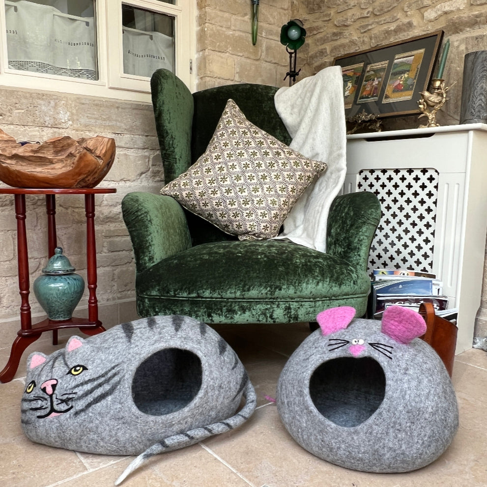 The &#39;Mouse&#39; to the &#39;Cat&#39; felted wool pet cave is your furry friend&#39;s dream hideaway!

Handcrafted from 100% pure New Zealand wool and coloured with natural dyes, it&#39;s soft, warm, and wonderfully breathable—keeping your pet cosy without any nasty chemicals.

It&#39;s the perfect snug retreat that folds away neatly when not needed. Beyond being a pet paradise, it doubles as quirky room décor or clever storage. Shown on a stone floor, against a green velvet armchair, with cashmere blanket and decorative items. 