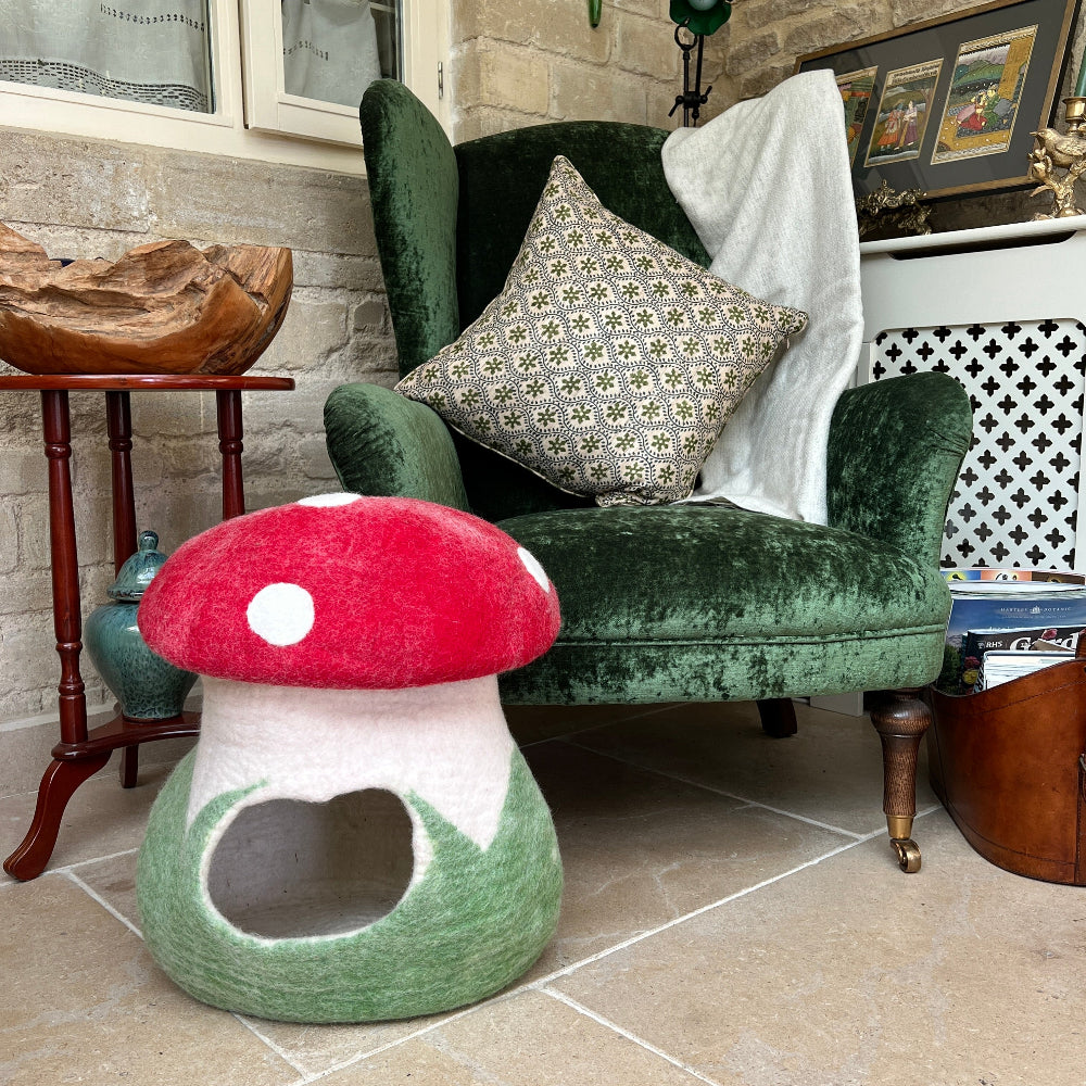 This charming toadstool-shaped felted wool cave is your pet&#39;s dream hideaway!

Handcrafted from 100% pure New Zealand wool and coloured with natural dyes, it&#39;s soft, warm, and wonderfully breathable—perfect for cosy naps. Beyond being a snug pet bed, it doubles as quirky room décor or handy storage that folds away easily.&amp;nbsp;

Ethically made by a small family business using sustainable, chemical-free practices. Shown against a green velvet armchair on a stone floor with a cashmere blanket and magazines.