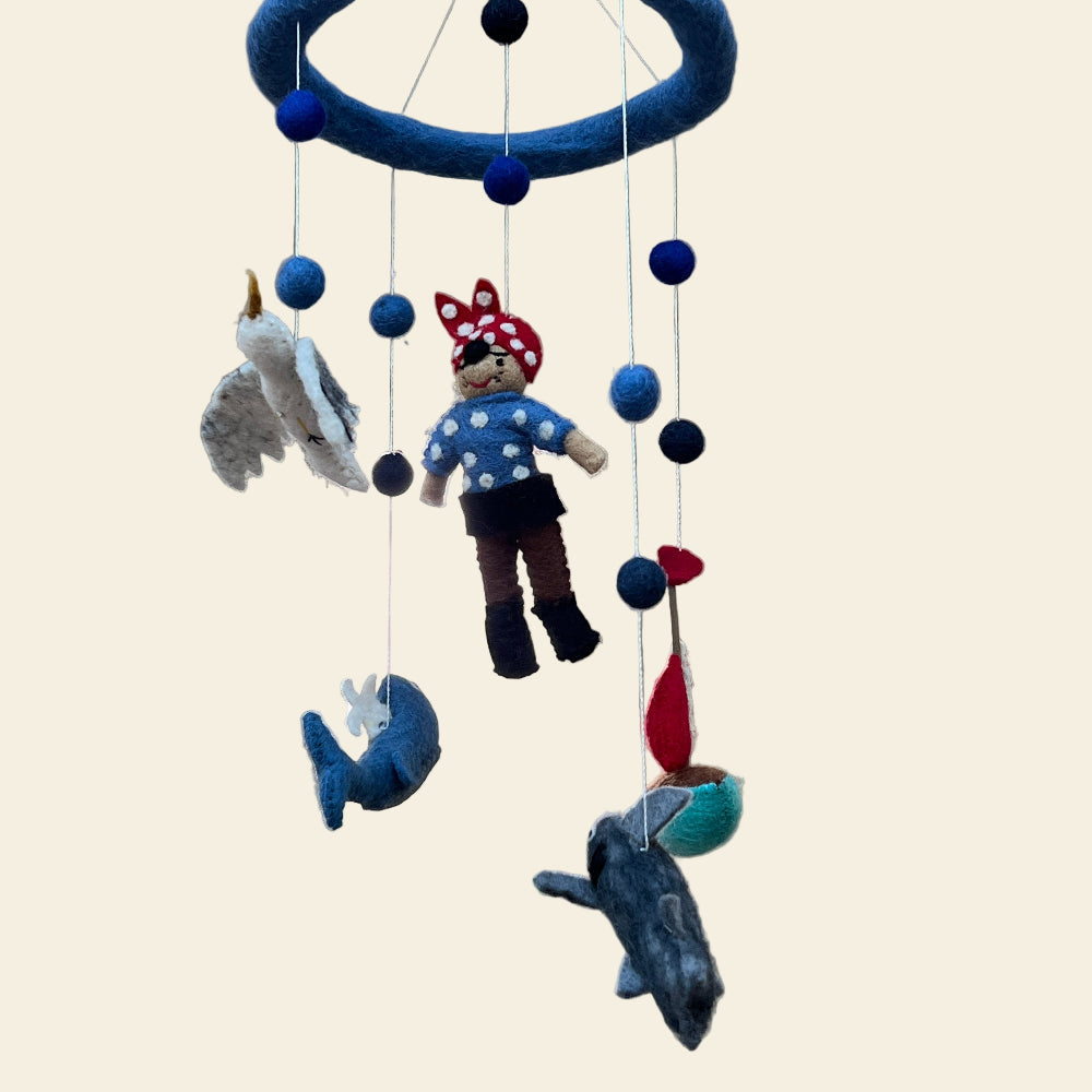 Handcrafted, felted wool Pirate and Ship children's toy mobile with various hanging characters.
