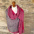 Handwoven Cashmere Reversible Pashmina - Pink & Grey.  Mannequin  wearing a pink and gray cashmere scarf against a cotswold stone wall background