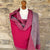 Handwoven Cashmere Reversible Pashmina - Pink & Grey.  Mannequin  wearing a pink and gray cashmere scarf against a cotswold stone wall background
