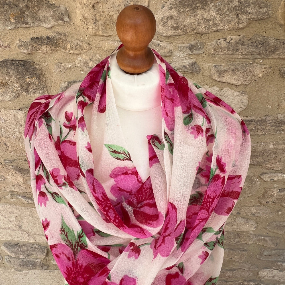 Cashmere Floral scarf / pashmina on a mannequin against a stone wall background