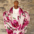Floral  cashmere scarf on a mannequin against a stone wall background
