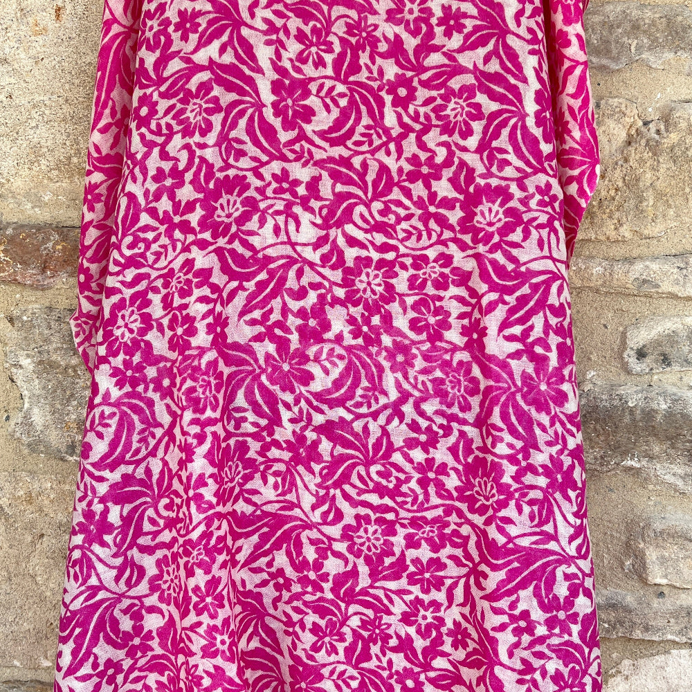 Pink Abstract Floral Cashmere Pashmina Scarf against a stone wall background.