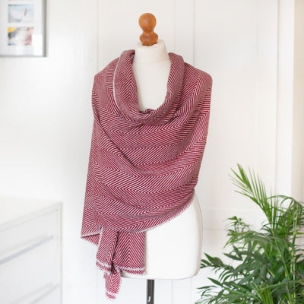 Cashmere Scarf / Wrap - Ruby Red Herringbone design on a mannequin against a white background with a green fern plant.
