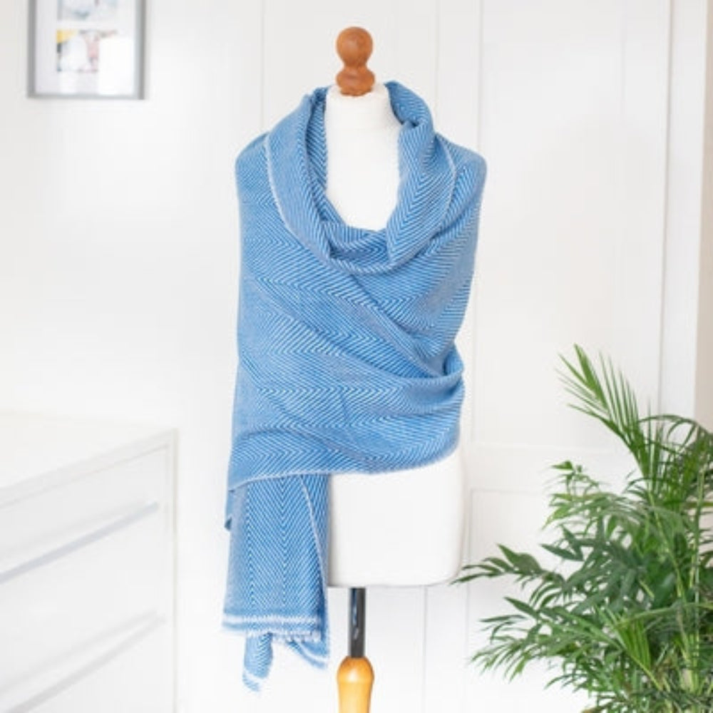 Cashmere Scarf / Wrap - Sky Blue Herringbone design on a mannequin against a white background with a green fern plant decoration.