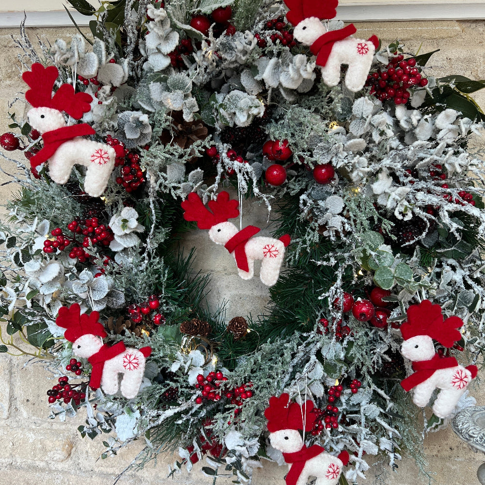 Douée Celebrate the festive season with this lovingly handcrafted crafted reindeer ornament, made from soft New Zealand felted wool with careful hand finishing throughout.&amp;nbsp;

Featuring a cheerful red scarf and a delicate hand-embroidered snowflake, this charming piece brings warmth and personality to your festive display. Whether hanging solo or grouped with other Douée creations, it&#39;s a wonderful way to honour traditional, artisan craftsmanship and add a touch of handmade magic.