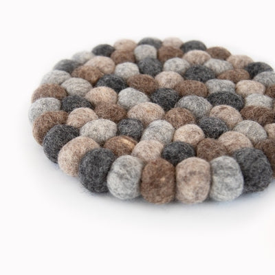 This handcrafted felted wool trivet combines a warm colour design with durable, sustainable materials.

Its hardwearing construction offers reliable protection for your surfaces while adding an elegant bright touch of colour to your home.  Shown as a close up on a white background.
