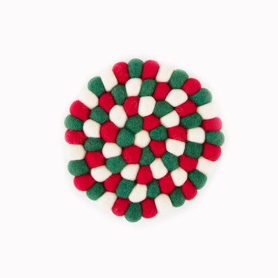 This handcrafted felted wool trivet combines a strong festive red, white &amp;amp; green design with durable, sustainable materials.

Its hardwearing construction offers reliable protection for your surfaces while adding an elegant bright touch of colour to your home. Shown as a close up on a white studio backdrop.