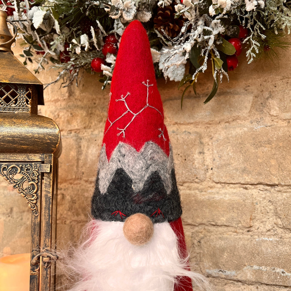 This exquisite Father Christmas figure is a timeless piece, meticulously hand crafted with intricate embroidery and appliquéd accents. Each heart motif is delicately embroidered and adorned with clear beads, while Santa’s hat features detailed hand stitching and beading.

Standing 18" (46cm) tall with a 5.5" (14cm) diameter base, this softly filled figure is lightweight and elegantly designed to enhance your holiday décor.