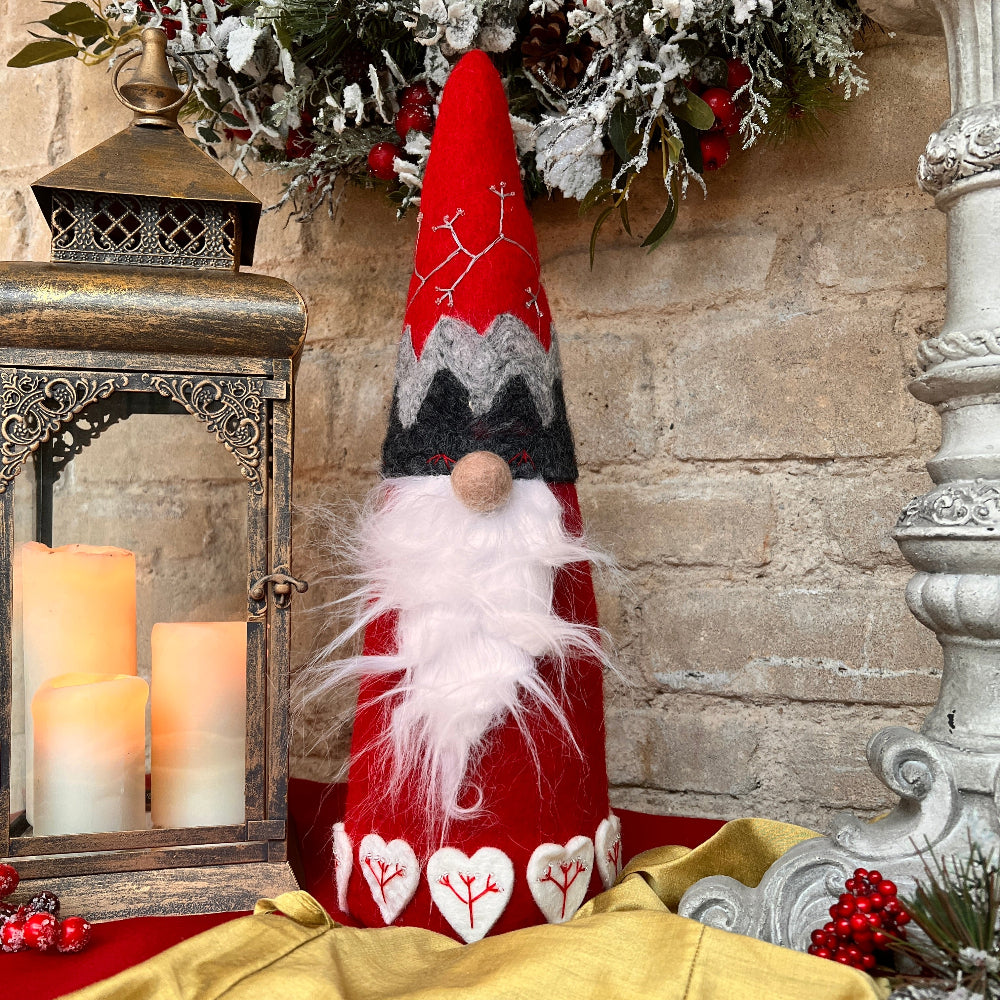 This exquisite Father Christmas figure is a timeless piece, meticulously hand crafted with intricate embroidery and appliquéd accents. Each heart motif is delicately embroidered and adorned with clear beads, while Santa’s hat features detailed hand stitching and beading.

Standing 18" (46cm) tall with a 5.5" (14cm) diameter base, this softly filled figure is lightweight and elegantly designed to enhance your holiday décor.
