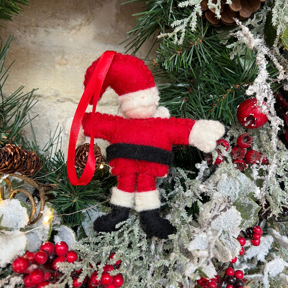 This charming Father Christmas ornament brings timeless elegance to your festive décor.

Crafted from premium New Zealand felted wool, each piece features hand-applied embellishments and delicate embroidery that showcase artisanal quality.  He&#39;s the perfect size for tree displays or shelf arrangements. Shown on a Christmas wreath against a cotswold stone wall. 