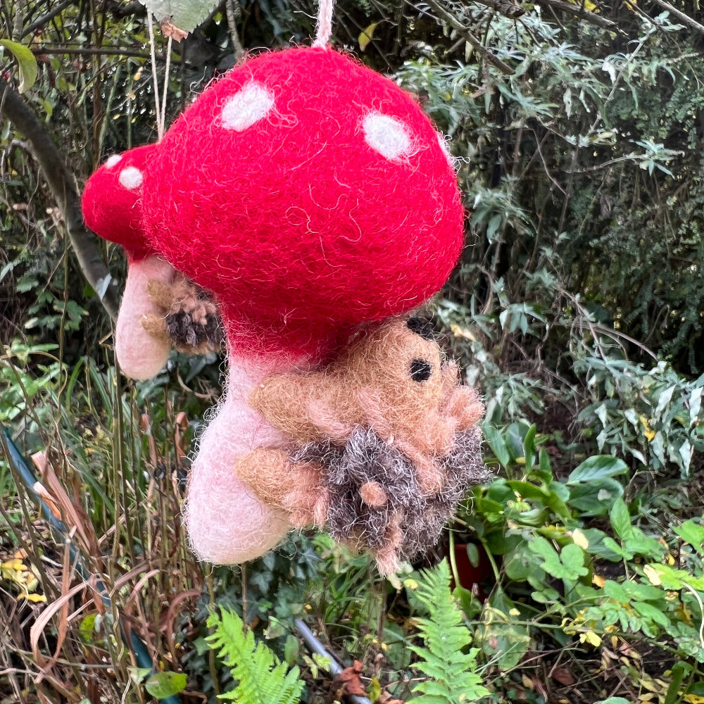 Handcrafted Felted Wool &#39;Woodland Toadstool&#39; with Hedgehog hanging from a countryside tree with red berries