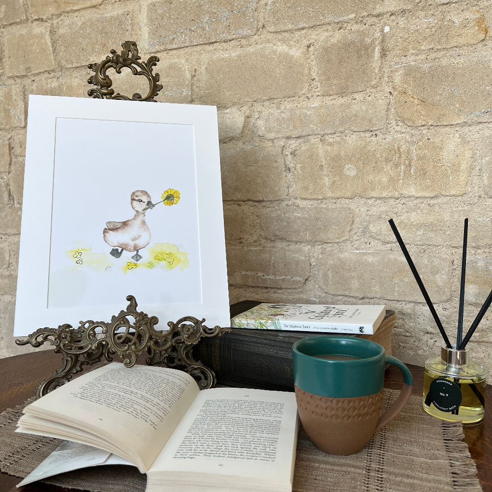 

&#39;Dandelion Duckling&#39; is a charming limited edition mounted print by artist Linda Beazley.

This delightful watercolour print captures a sweet duckling surrounded by fluffy dandelion seeds, bringing a whimsical touch to any room. Perfect for art lovers and nature enthusiasts alike, it brightens your space with a splash of playful elegance.

Whether gifted or kept as a treasured keepsake, this enchanting print invites joy and warmth into your home. Hurry—this exclusive piece is sure to flutter away quickly!