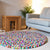 Rectangular Handcrafted Felted Wool Rugs - Multicolour available by Douée on a natural colour carpet in a room with tables and a natural colour sofa against a neutral wall with a green plant for decoration. 
