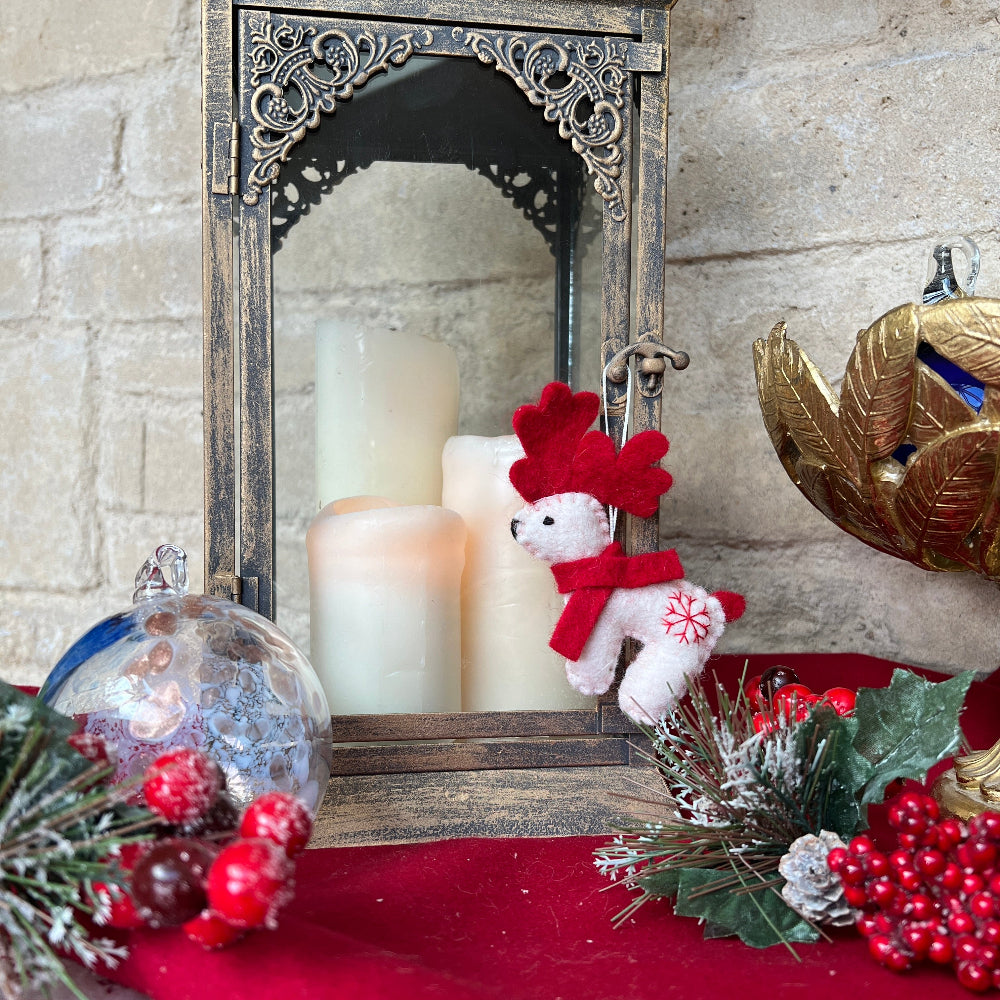 Douée -Celebrate the festive season with this lovingly handcrafted crafted reindeer ornament, made from soft New Zealand felted wool with careful hand finishing throughout.&amp;nbsp;

Featuring a cheerful red scarf and a delicate hand-embroidered snowflake, this charming piece brings warmth and personality to your festive display. Whether hanging solo or grouped with other Douée creations, it&#39;s a wonderful way to honour traditional, artisan craftsmanship and add a touch of handmade magic.