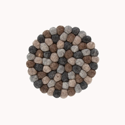 This handcrafted felted wool trivet combines a warm colour design with durable, sustainable materials.

Its hardwearing construction offers reliable protection for your surfaces while adding an elegant bright touch of colour to your home.  Shown as a close up on a white backdrop.