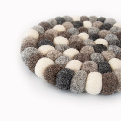 This handcrafted felted wool trivet combines a warm colour design with durable, sustainable materials.

Its hardwearing construction offers reliable protection for your surfaces while adding an elegant bright touch of colour to your home.

Shown as a close up on a white backdrop. 
